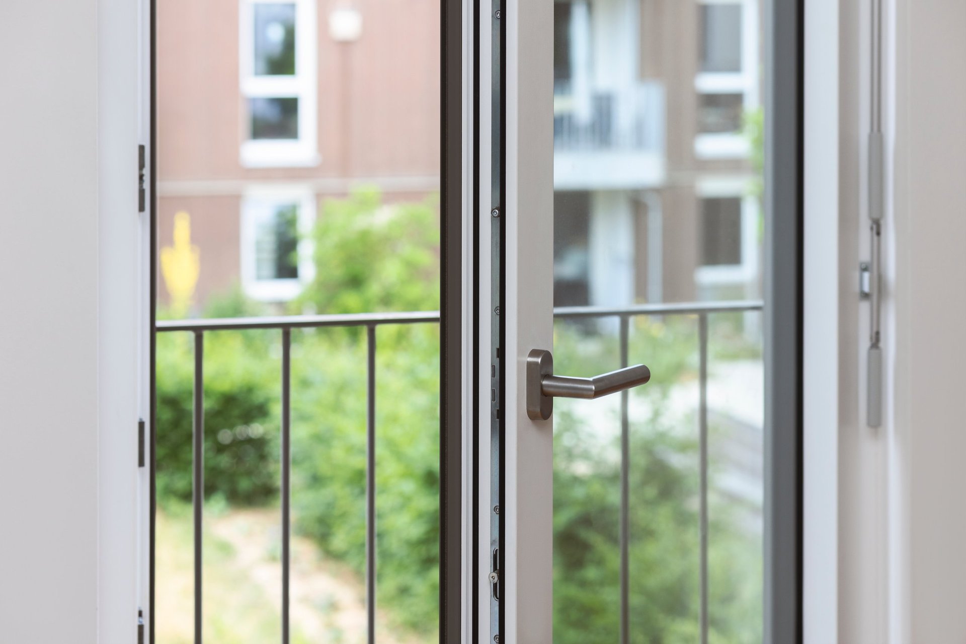 Aluminium hinged French balcony doors with glass panes, open