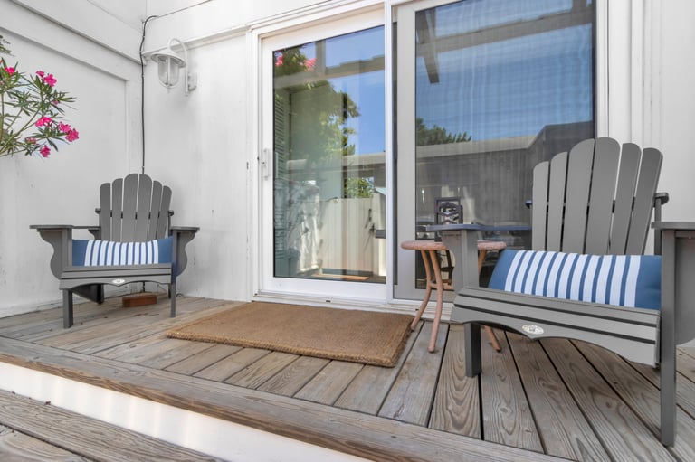 Aluminium sliding glass door opening onto a patio with outdoor seating