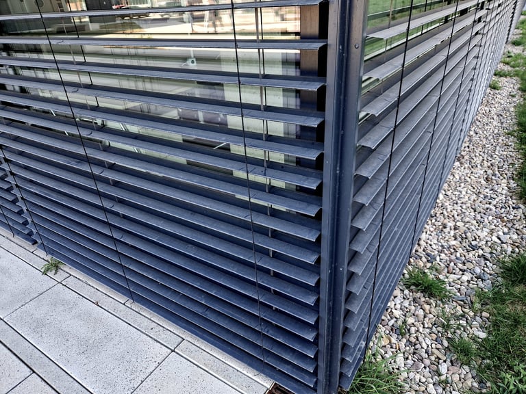 Aluminium hinged doors with integrated blinds and glazing in a bright interior